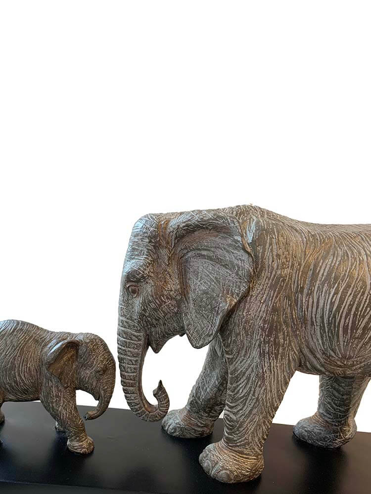 A large sculpture of a grey elephant with its baby