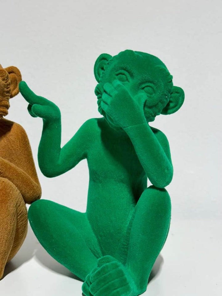 Three bright colour velvet monkey figurines 