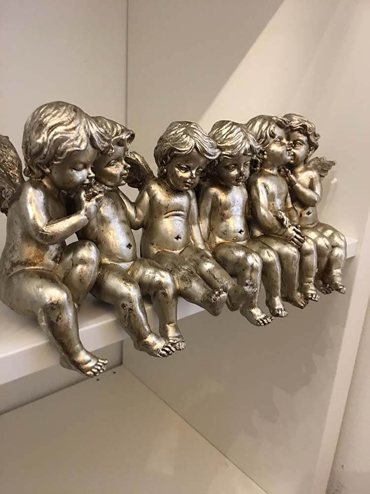 Sitting Row of Cherubs on shelves 